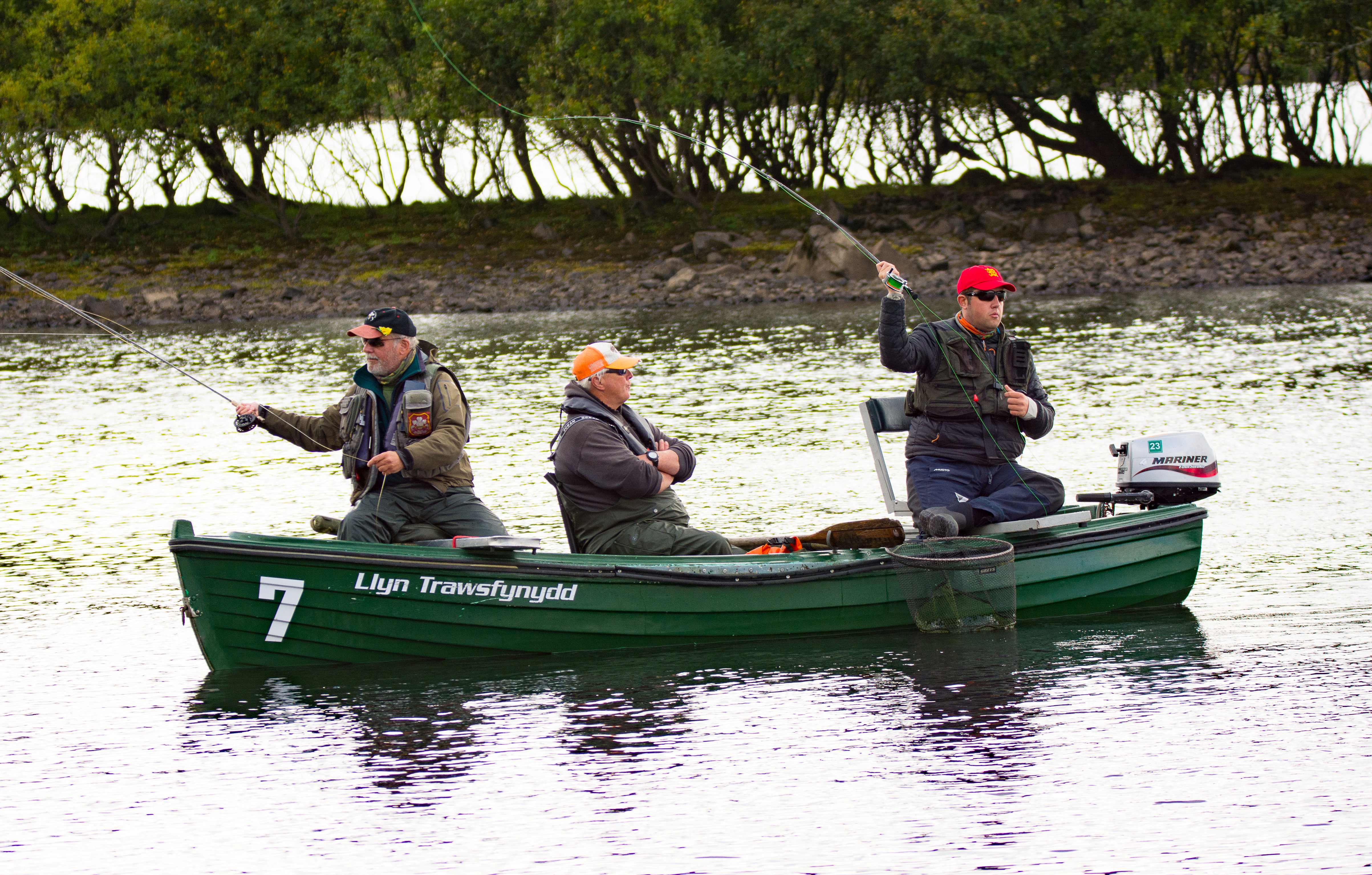 Three men in a boat fishing